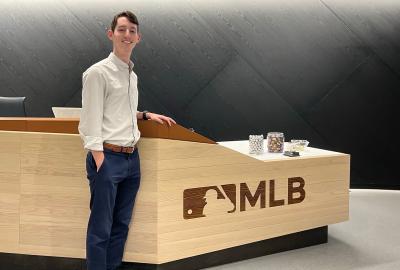 Josh Leeman standing in front of MLB desk