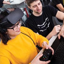 A group of computer science students working on a virtual reality project in a lab in the Iribe center