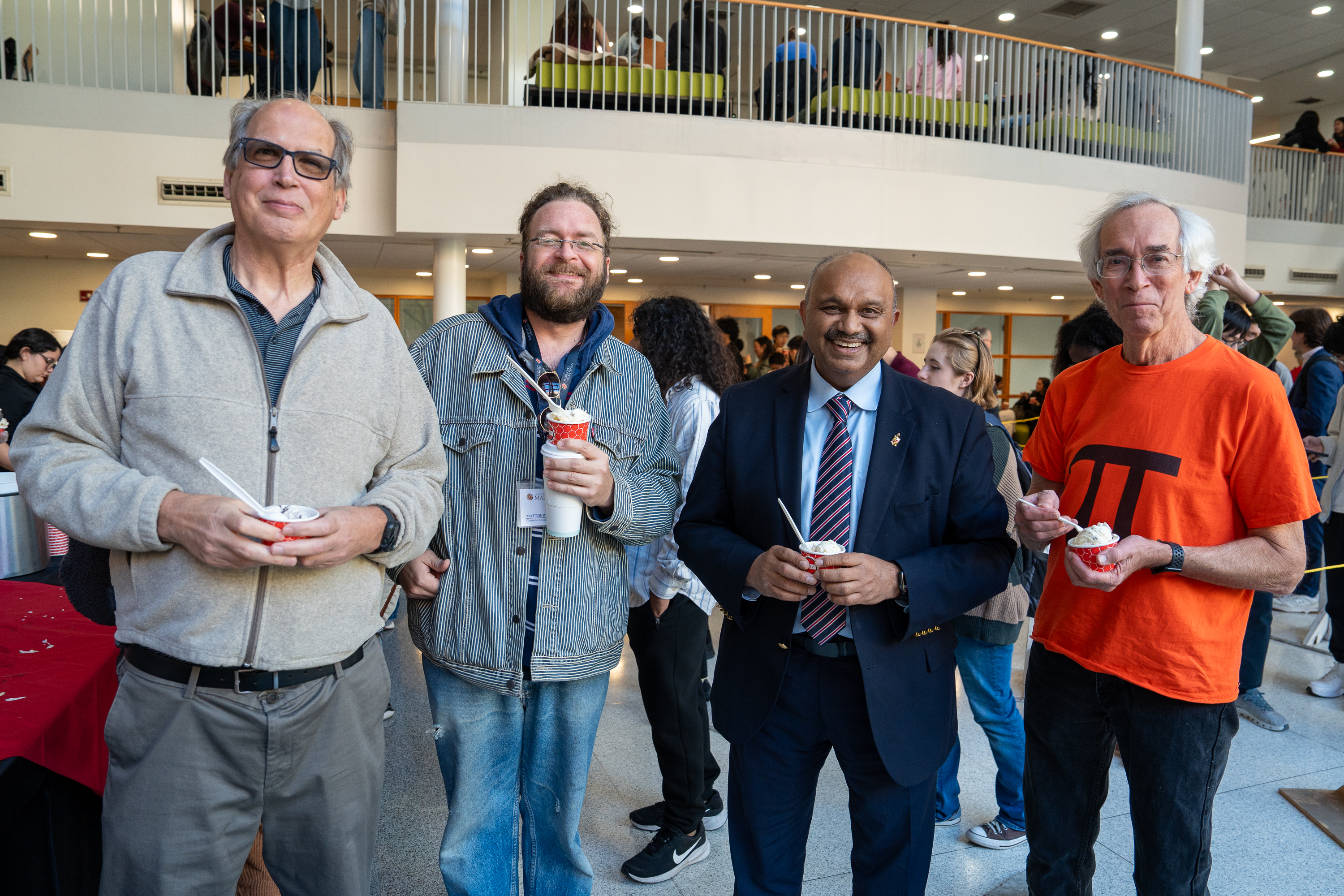 Four people holding ice cream cups