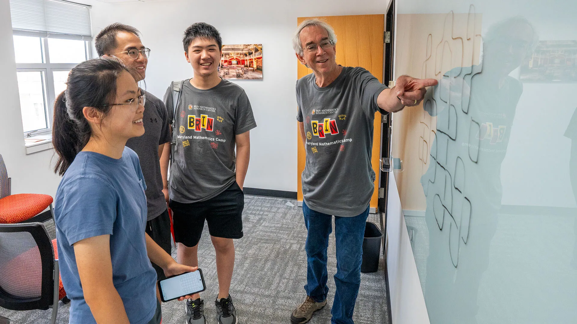 Professor Larry Washington works with students attending the first year of the Brin Maryland Mathematics Camp in 2024