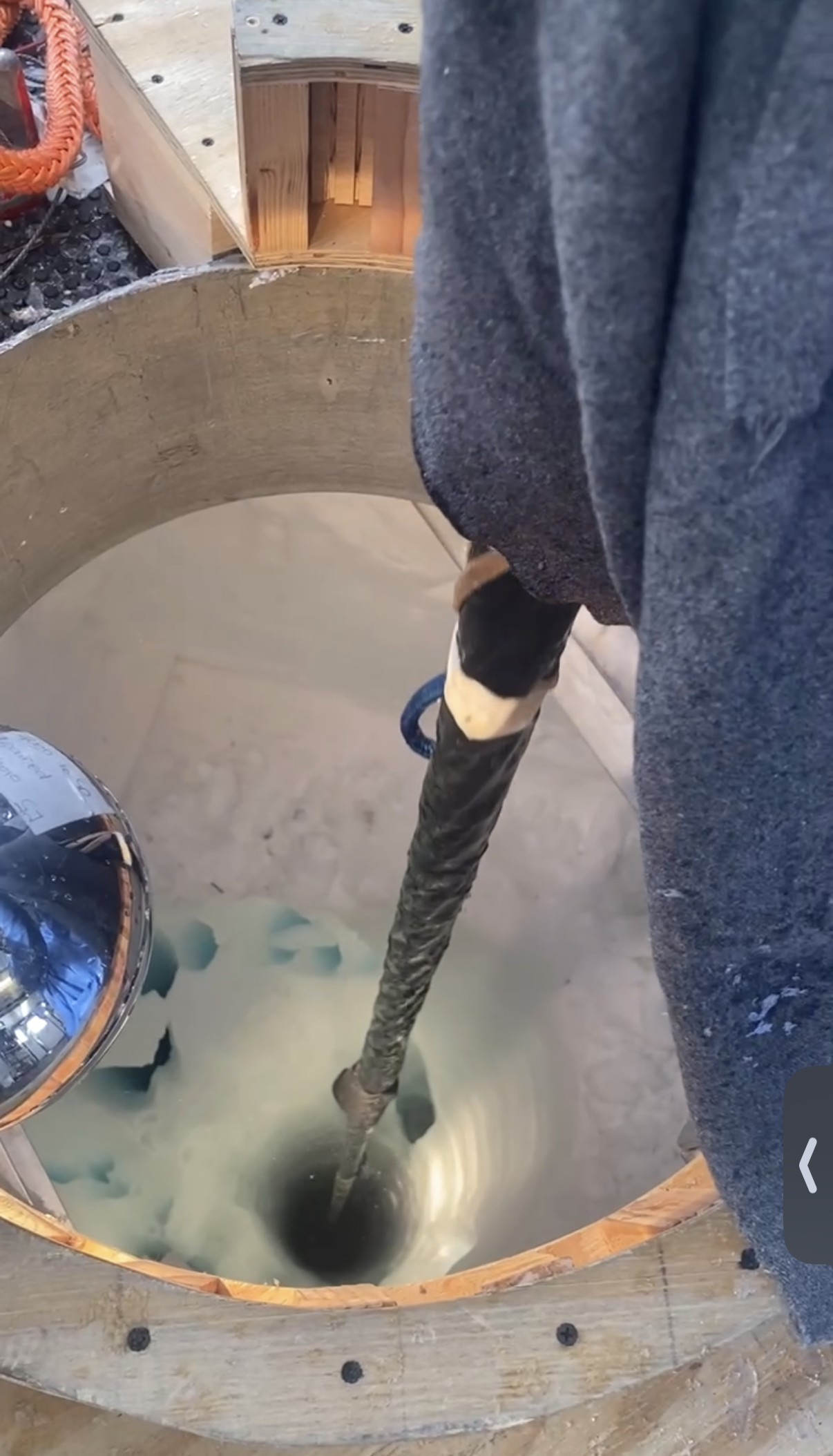 A massive drill bit going into the ice as part of an installation at the South Pole.