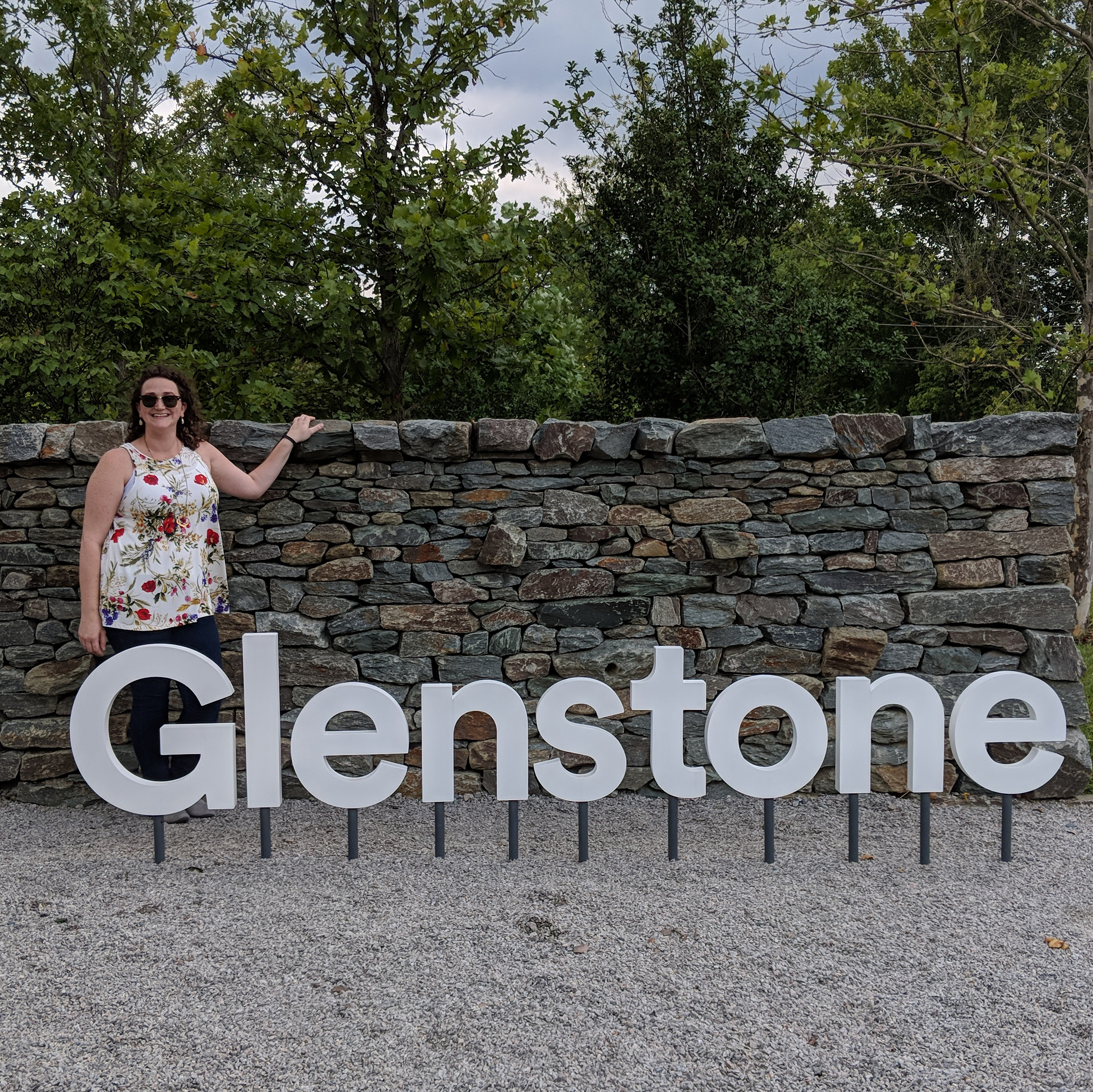 Samantha Halstead Santez standing behind a Glenstone sign