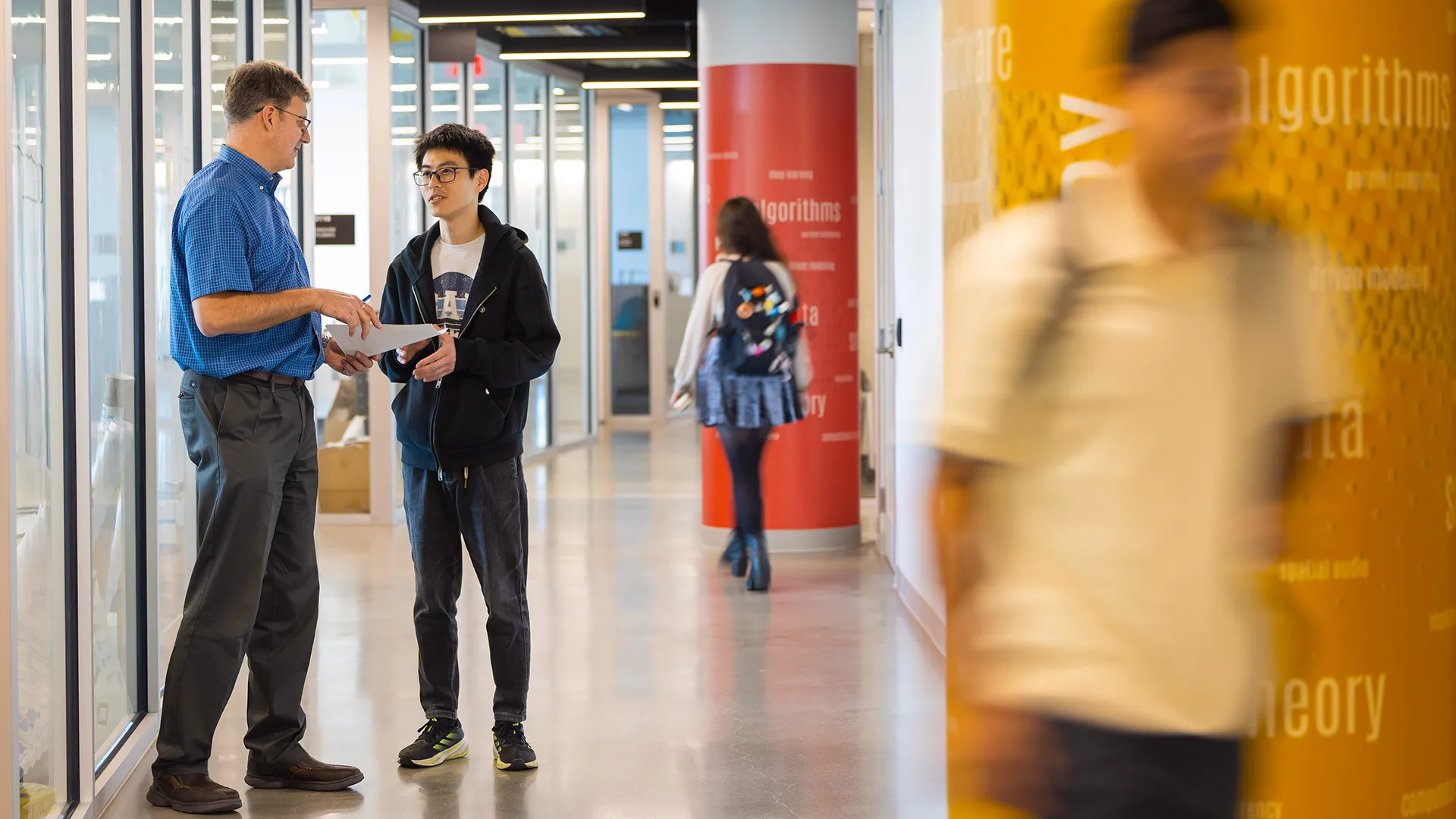 students and Mihai Pop in Iribe hallway