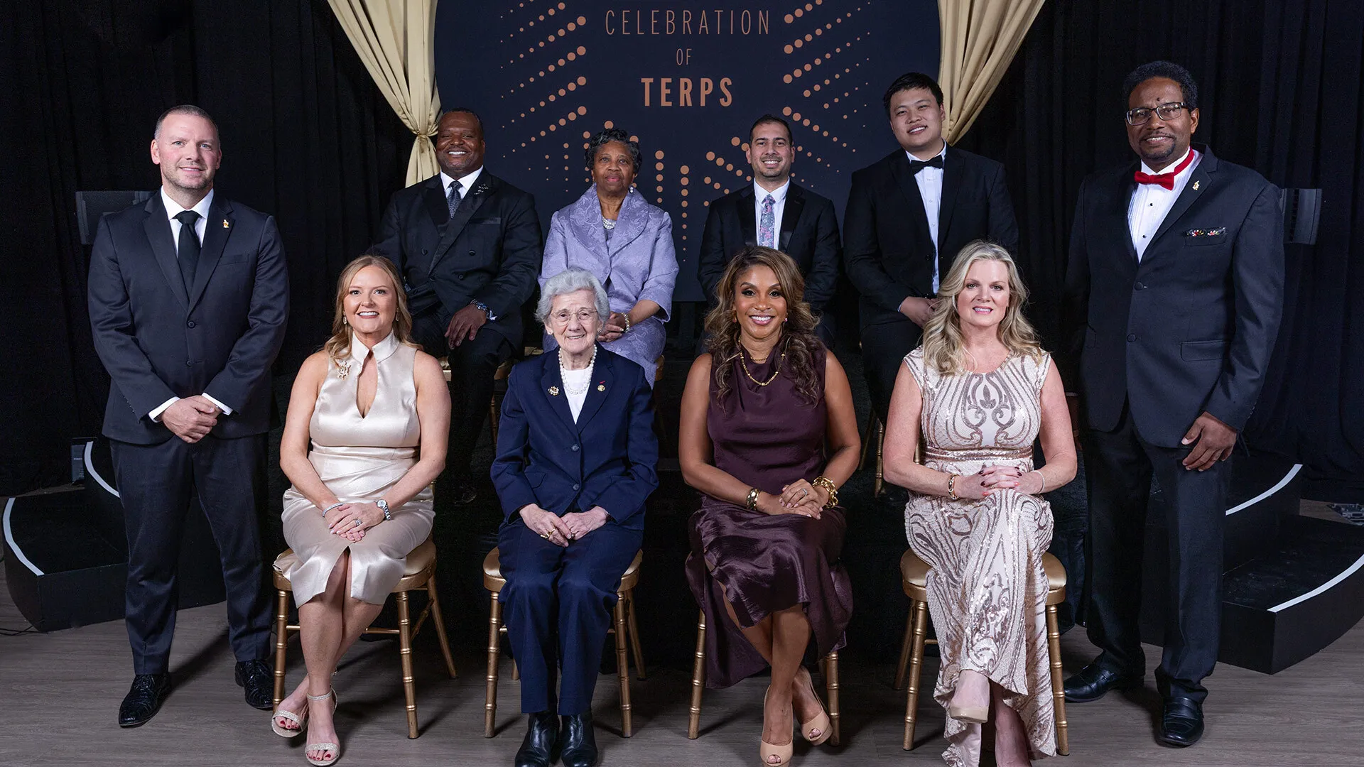 Vice President for University Relations Jim Harris (far left) and Alumni Association Board of Governors President Bert D. Williams '96 and UMD President Darryll J. Pines (far right) flank the 2025 honorees of "A Celebration of Terps." Back row, from left: Margot Thomas '90, Omar Tarabishi ’13, M.A. ’20 and Kevin J. Tu ’23, ’23. Front row: Alumni Association Executive Director Jessica Roberts, Rita R. Colwell, Dawn Flythe Moore '97 and Jackie Cardello ’93.