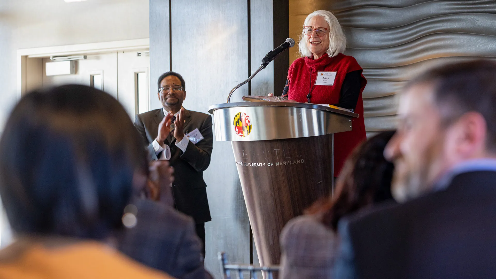 Anne Simon at podium at President's Impact Award