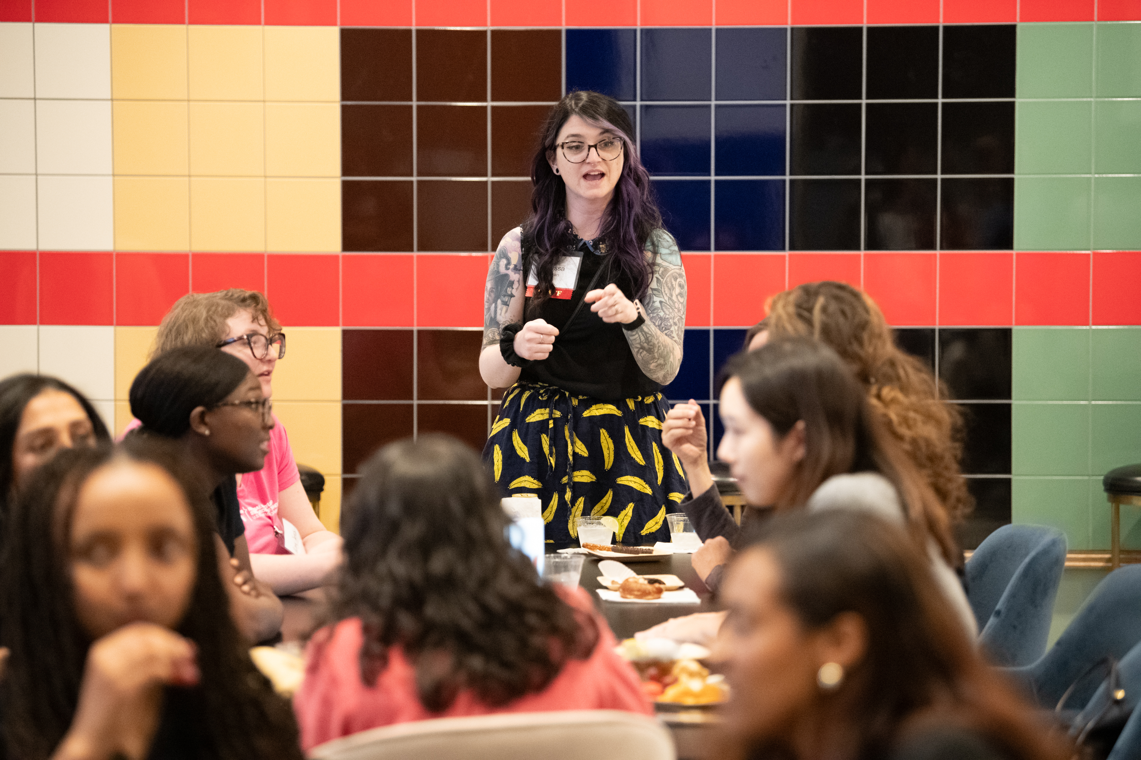 Alyssa Ryan speaking to people at the Terps in Tech alum event at the Grace Hopper Celebration