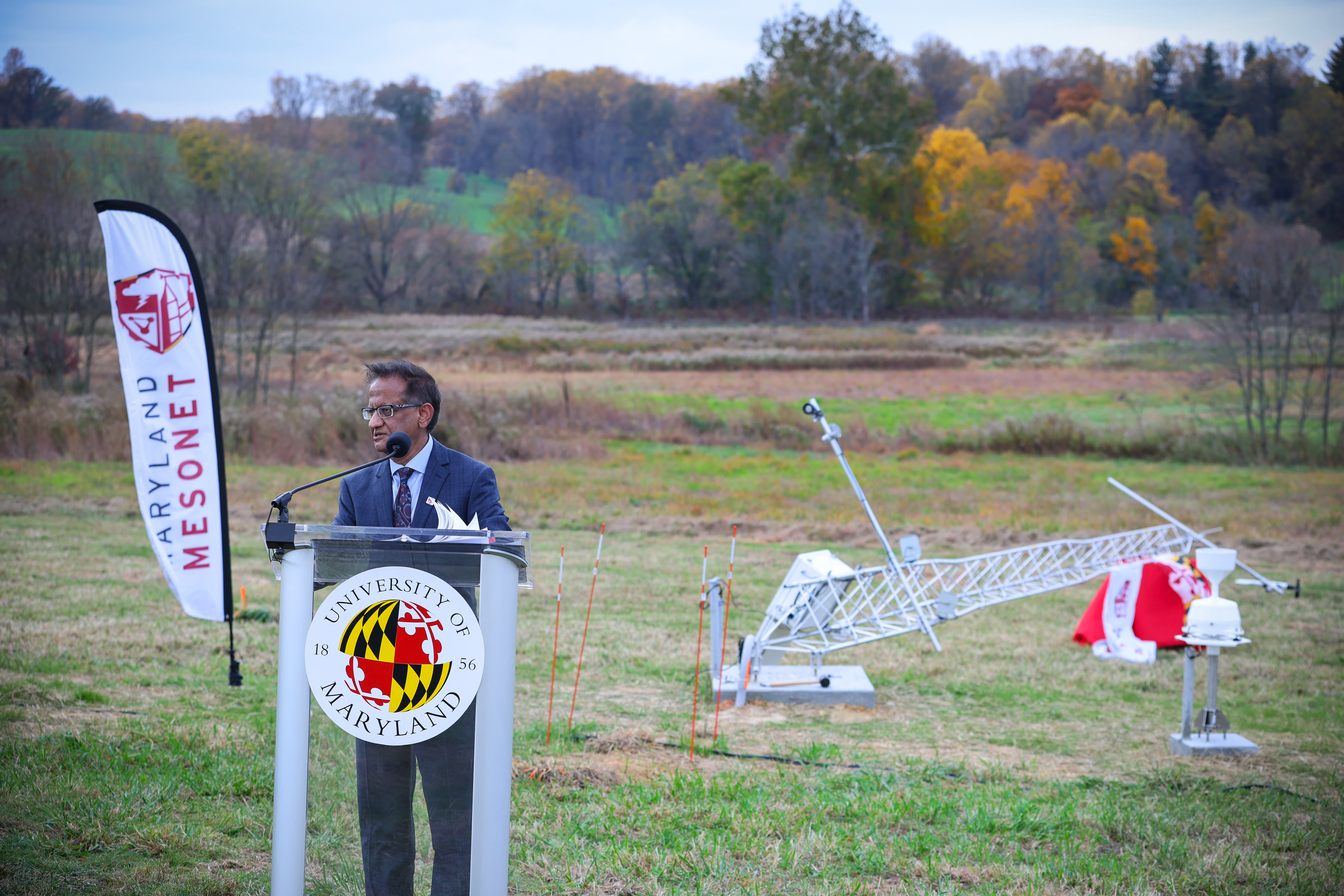 Atmospheric and Oceanic Science Department Chair Sumant Nigam stands at a podium during the inauguration event for the first Maryland Mesonet tower.