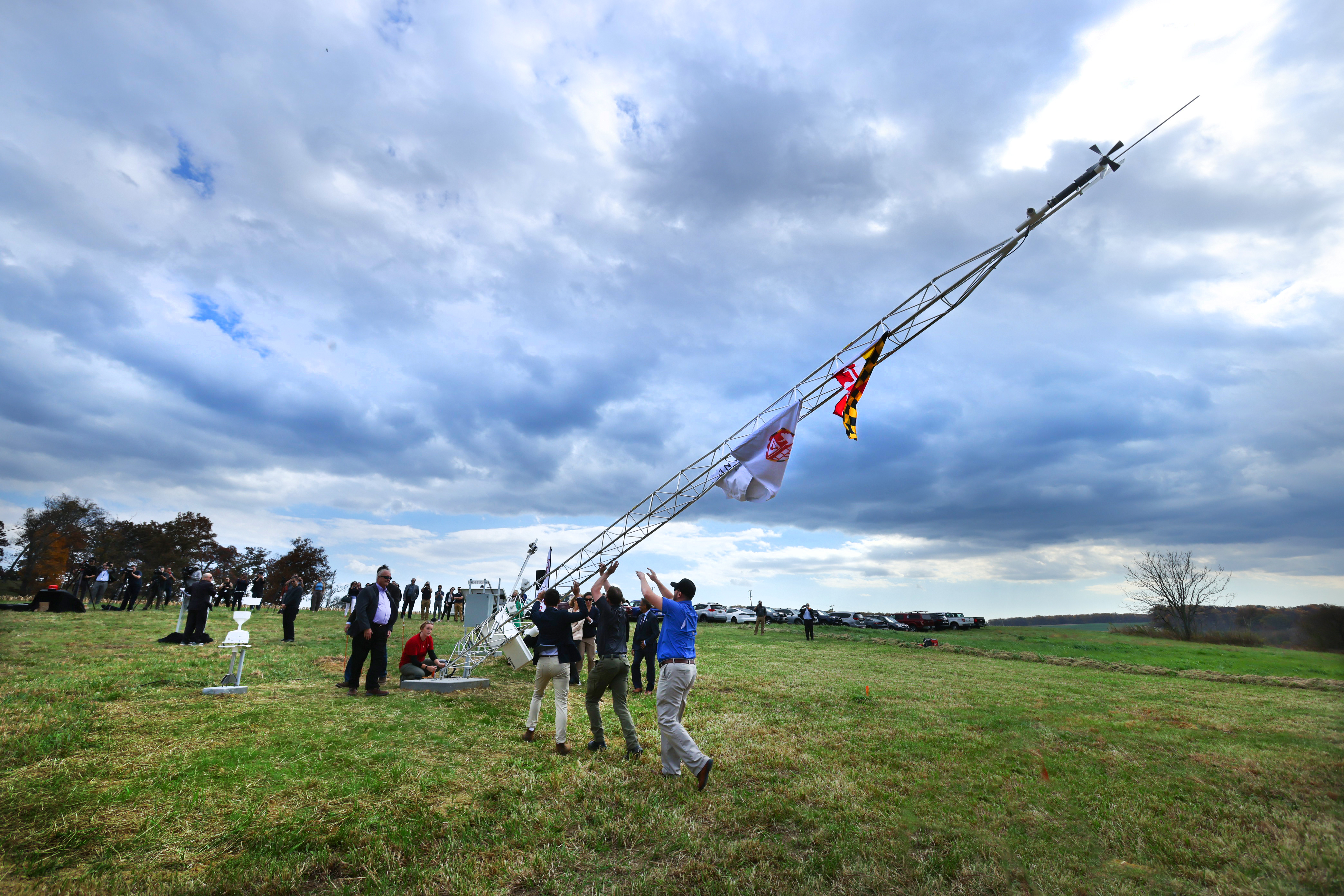 A team of researchers and graduate students lift up the first tower of the Maryland Mesonet network.