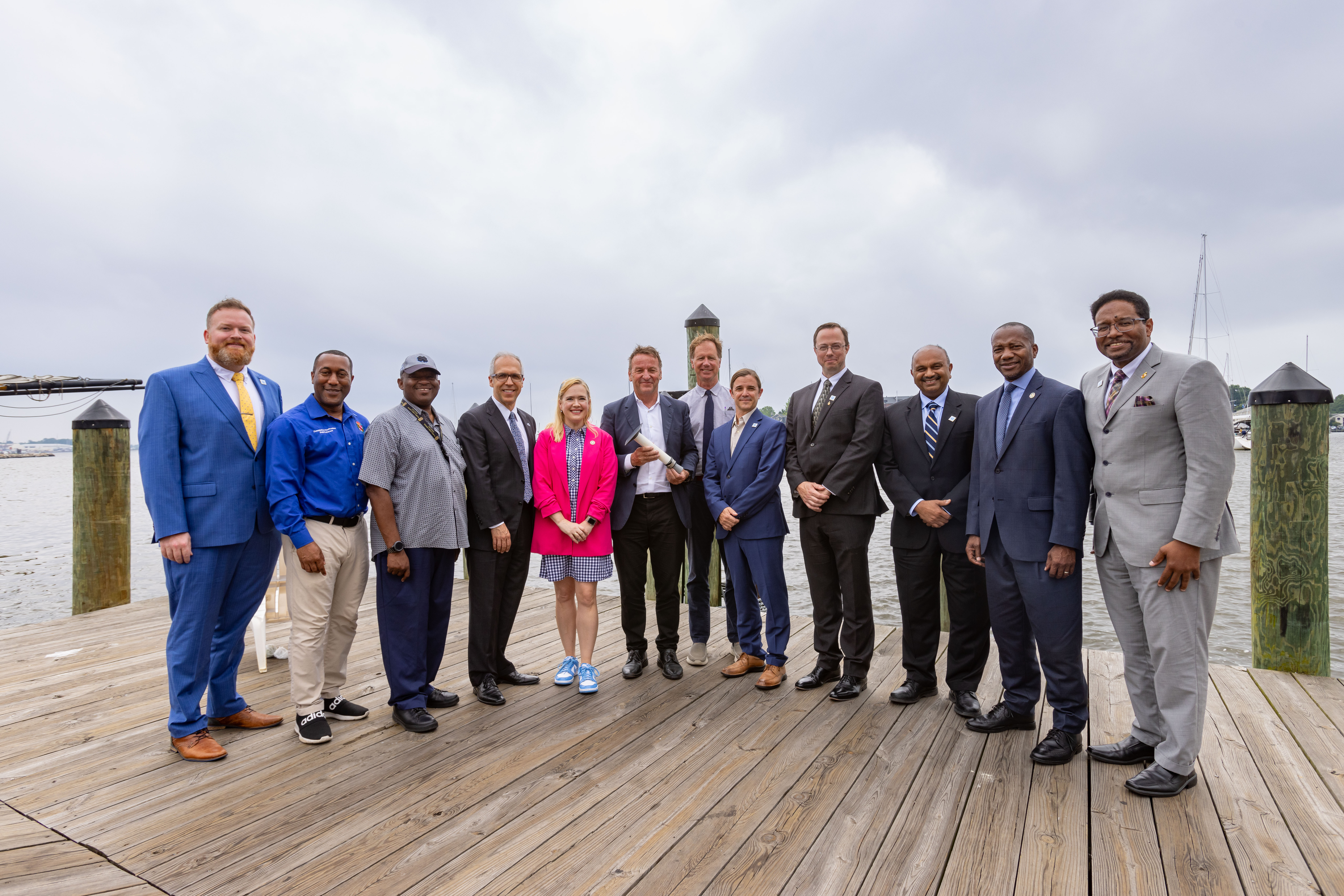 Group of university and public officials standing at Annapolis City Dock