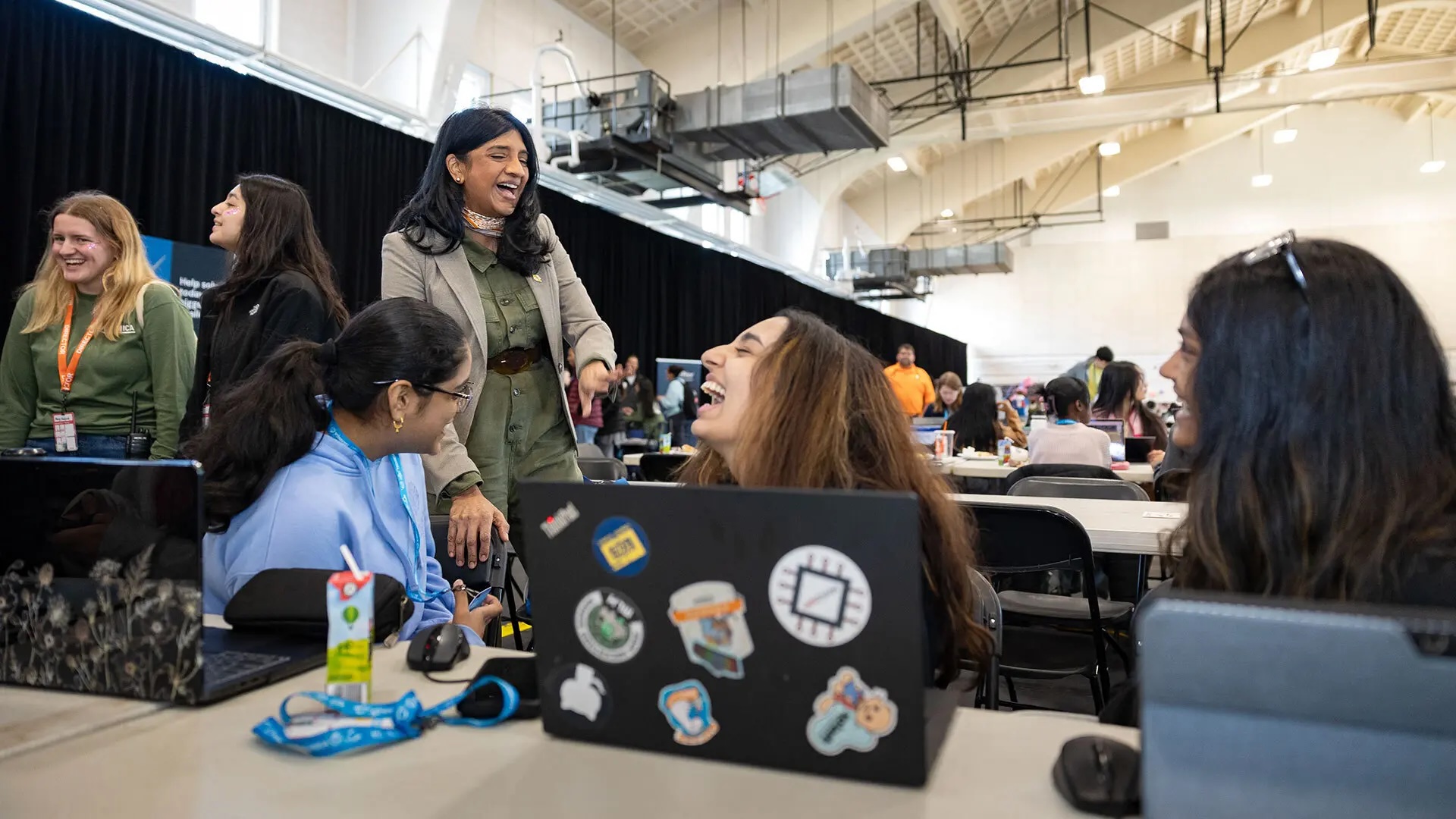 Lt. Gov. Aruna Miller talks at Technica with the South Brunswick, N.J.-based team of (from left) Bhavya Tanugula ’28, South Brunswick High School senior Anika Thakur and Esha Vigneswaran ’28. The trio developed an app called “Locked In,” which aims to help students focus on homework by blocking users from accessing distracting websites and providing warnings to users when their eye movements stray from their computer screens.  Photos by Riley N. Sims