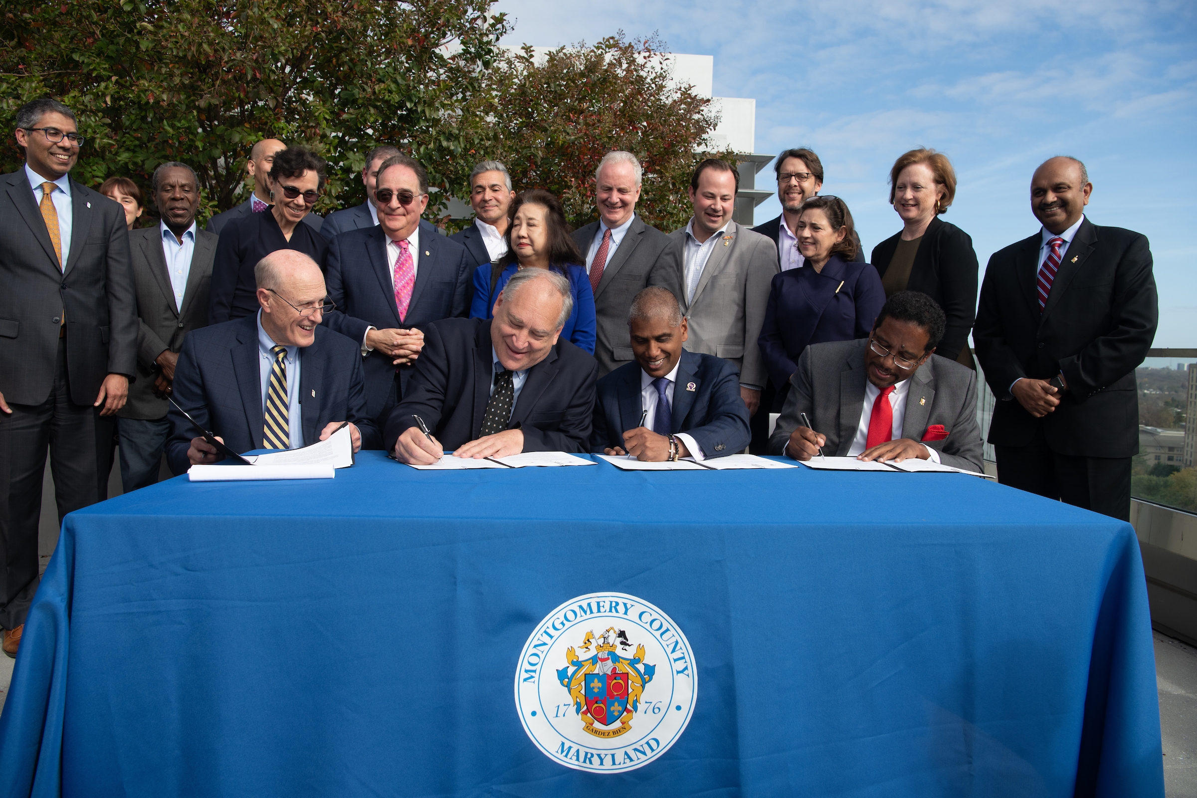 From left: University of Maryland, Baltimore President Bruce Jarrell, Montgomery County Executive Marc Elrich, President and CEO of the University of Maryland Medical System, Mohan Suntha, and University of Maryland, College Park President Darryll Pines sign a memorandum of understanding to establish the University of Maryland 3 - Institute for Health Computing (UM-3-IHC). (Photo credit: University of Maryland, Baltimore)