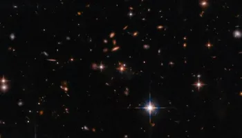 James Webb Space Telescope Uncovers Massive Galaxy Cluster Surrounding a Powerful Red Quasar