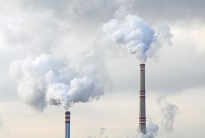 Smoke billows from a power plant