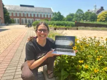 Entomology Associate Professor Anahí Espíndola holds a laptop promoting her Reddit Ask-Me-Anything