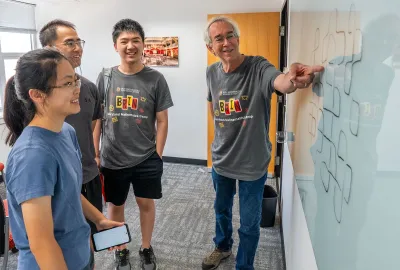 Professor Larry Washington works with students attending the first year of the Brin Maryland Mathematics Camp in 2024