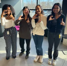 Capital One Sprinterns posing with "C 1" hand symbols