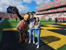 Testudo posing with Hallie Pennington and Collin Vincent after they got engaged at SECU Stadium