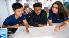 Students gathered around laptop
