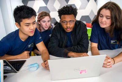 Students gathered around laptop