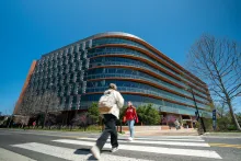 Exterior of Iribe Center building with people walking across the street