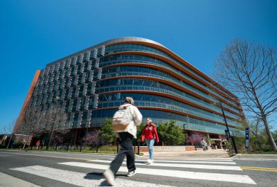 Exterior of Iribe Center building with people walking across the street