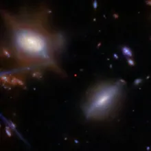 The red dot in the center is the galaxy JADES GS-z13-1, which existed very early in the universe. The JWST observed the galaxy as it existed approximately 13.5 billion years ago, just 330 million years after the big bang. 
