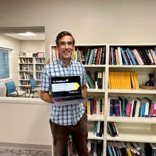 Joshua weitz holding a laptop