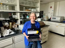 Karen Prestegaard holding a laptop in her lab