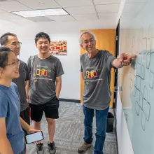 Larry Washington pointing to a whiteboard