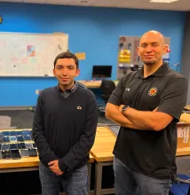 Researchers standing next to a table of cellphones