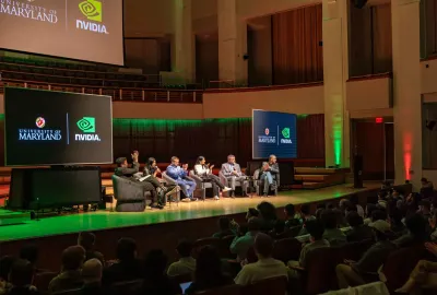 six panelists sit on stage