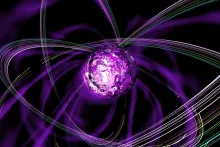 A purple ball has colorful strings of light looping around it at many different orientations