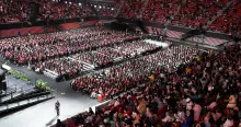Commencement at the Xfinity Center. A high view of the huge crowd of students and guest.