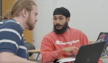 Harkeerat Sing having a discussion with another student