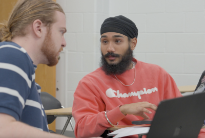 Harkeerat Sing having a discussion with another student