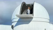 Kelly Fast stands in the ATLAS (Asteroid Terrestrial-impact Last Alert System) telescope in Sutherland, South Africa. 