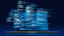 laptop with code floating above the screen