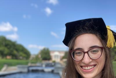 Jessica Kopew in her red UMD doctorate cap and gown.