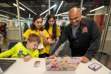 CMNS Dean Amitabh Varshney learns about CompSciConnect camper projects at Maryland Day 2024.