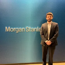 Nathan Frohna next to Morgan Stanley sign. Image courtesy of same.