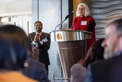 Anne Simon, professor of cell biology and molecular genetics, speaks to university colleagues after accepting the inaugural President’s Impact Award on Thursday from UMD President Darryll J. Pines, shown at left. 