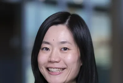 A woman, Dr. Yizheng Chen, smiling.