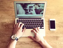 person typing on a laptop