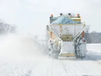 snow plow on the road in the snow