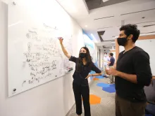 The Joint Center for Quantum Information and Computer Science (QuICS) recently received a renewal in federal funding that will allow the center to expand its research and educational activities, including additional support for postdocs and graduate students. UMD computer science Ph.D. student Manasi Shingane (left) discusses her work with postdoc Atul Mantri (right). Credit: John T. Consoli/University of Maryland. Click image to download hi-res version.