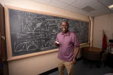 Abba Gumel in front of a chalkboard