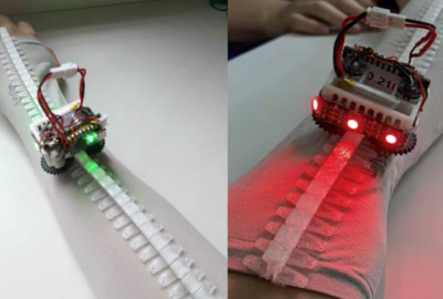 wearable mini robot running along track on person's arm