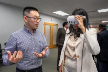 Sida Li with Lt. Gov. Miller wearing a VR headset