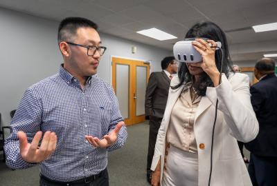 Sida Li with Lt. Gov. Miller wearing a VR headset