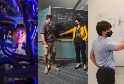Researchers pointing to a chalkboard